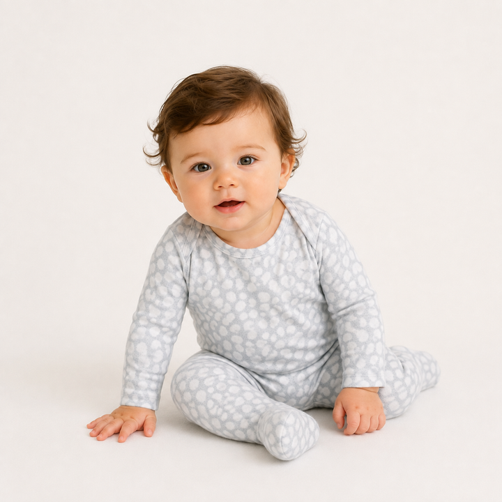 Baby sitting in PAIGELAUREN gray Brushed Hacci Animal Pajama with soft footed design