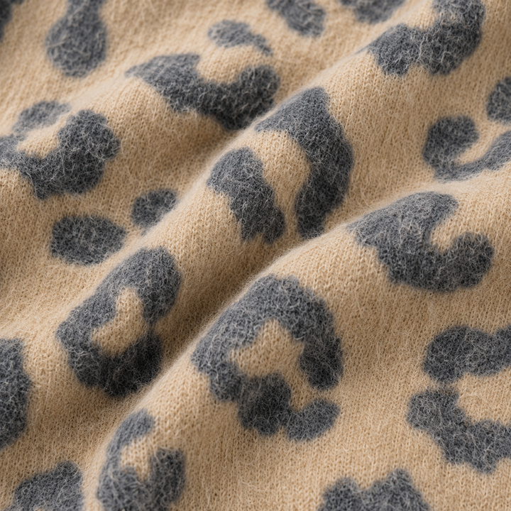 Close-up of the brushed Hacci fabric with a cashmere-soft texture and tonal animal print. Black/Taupe