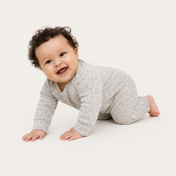 Baby crawling in the PAIGELAUREN Brushed Hacci Animal Henley Romper. Gray/Taupe