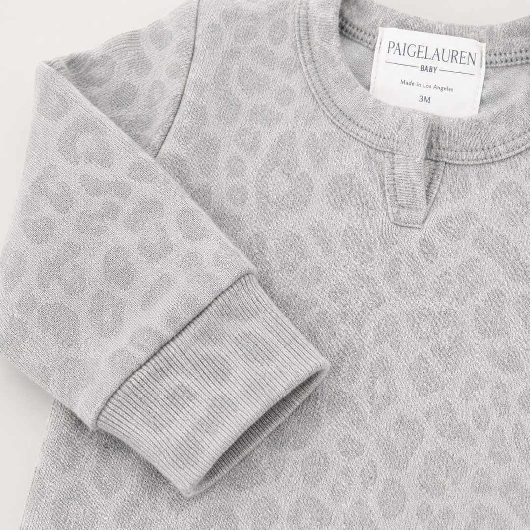 Henley neckline detail on the PAIGELAUREN Brushed Hacci Animal Henley Romper. Gray/Taupe