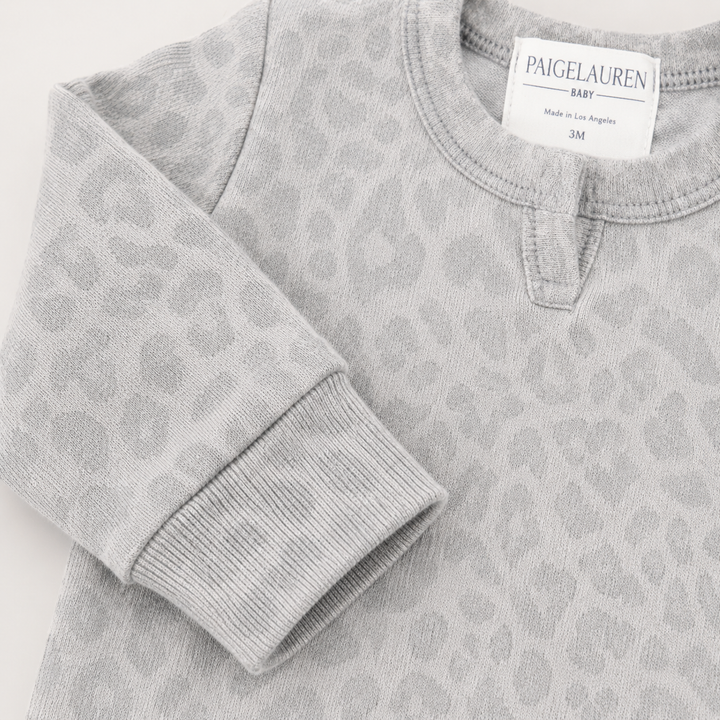 Henley neckline detail on the PAIGELAUREN Brushed Hacci Animal Henley Romper. Gray/Taupe