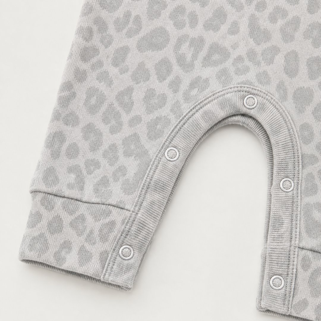 Color-matched snap closure detail on the PAIGELAUREN Brushed Hacci Animal Henley Romper. Gray/Taupe
