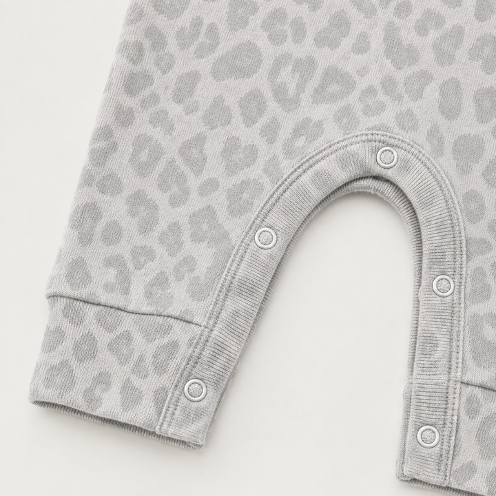 Color-matched snap closure detail on the PAIGELAUREN Brushed Hacci Animal Henley Romper. Gray/Taupe