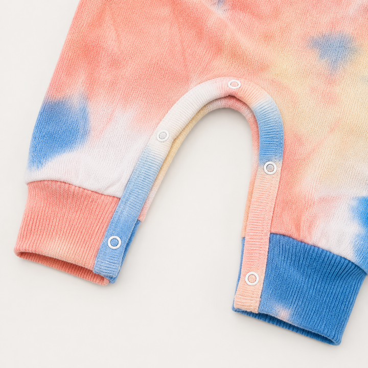 Color-matched snap closure on the PAIGELAUREN Brushed Hacci Multi Tie Dye Henley Romper.