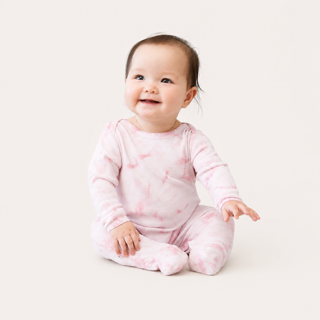 Baby wearing PAIGELAUREN Crystal Rib Footie Pajama in Pink Crystal