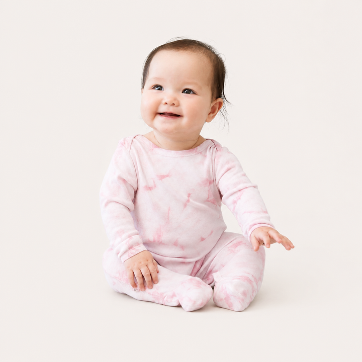 Baby wearing PAIGELAUREN Crystal Rib Footie Pajama in Pink Crystal