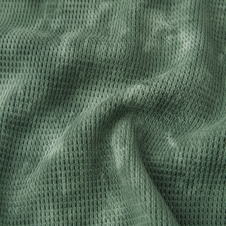 Close-up of PAIGELAUREN Dark Hunter Green hand-dyed thermal knit fabric texture