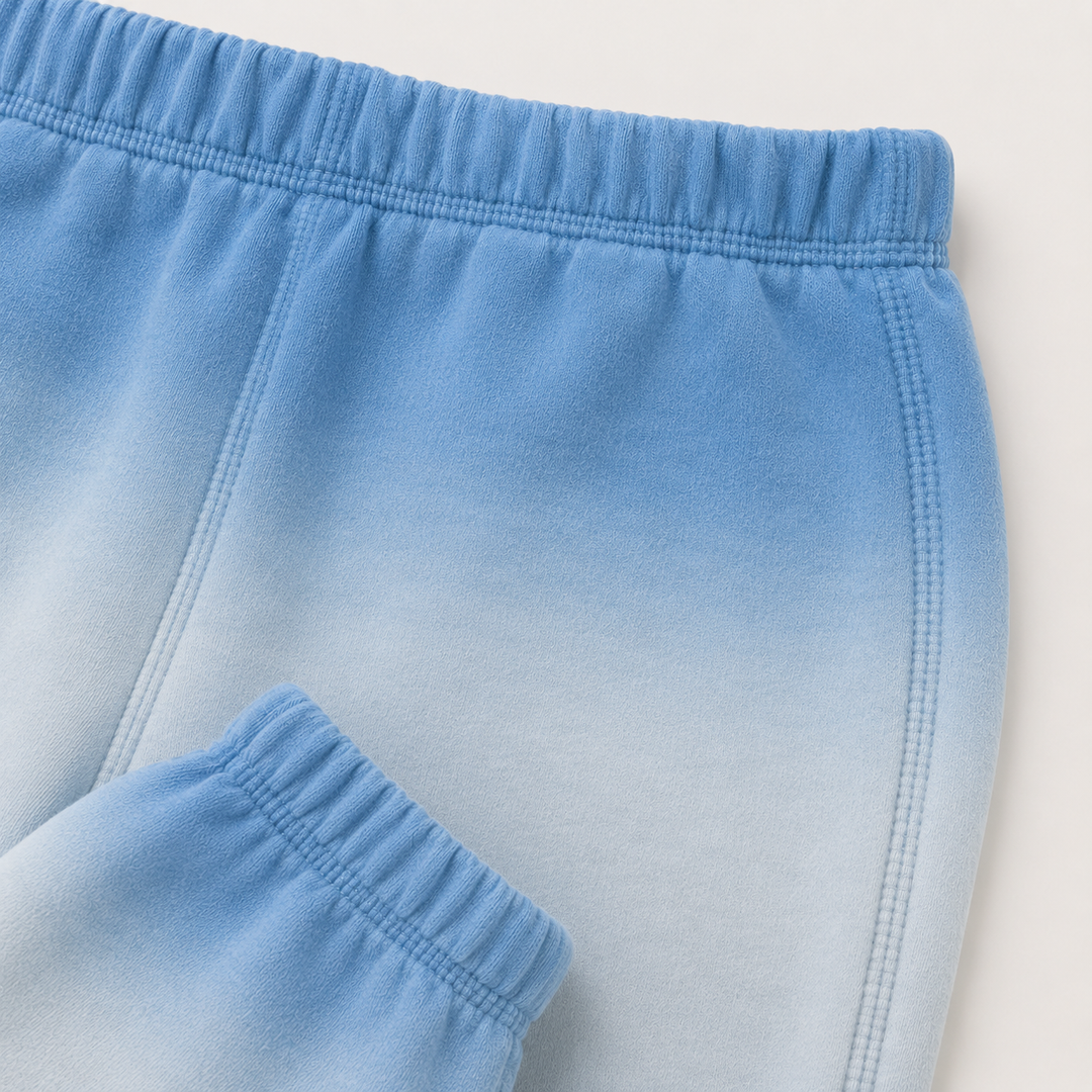 Close-up of PAIGELAUREN Ombre Blue dip dye fleece sweatpant construction and elastic waistband