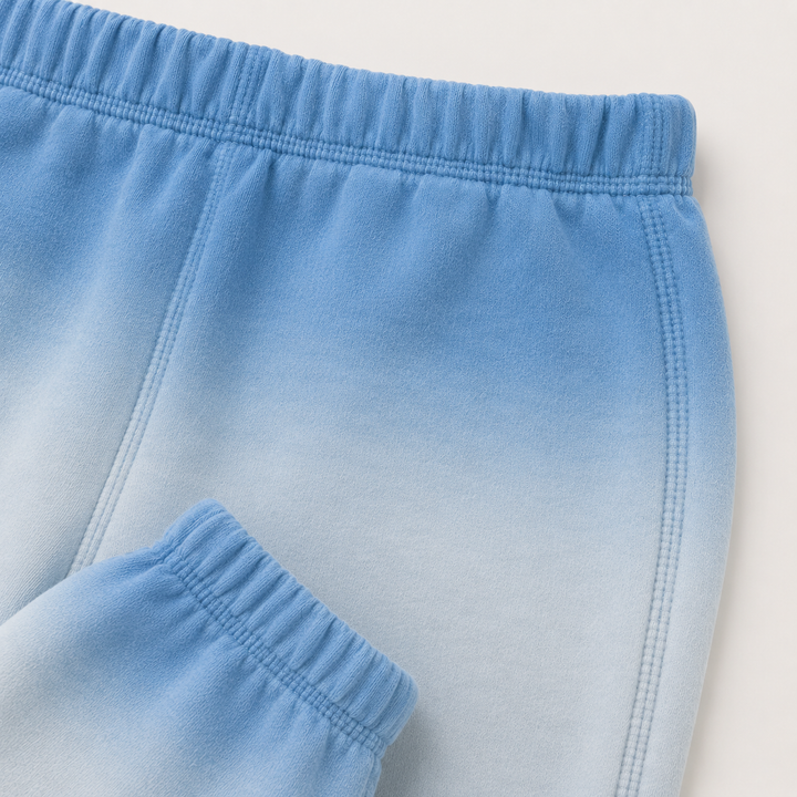 Close-up of PAIGELAUREN Ombre Blue dip dye fleece sweatpant construction and elastic waistband