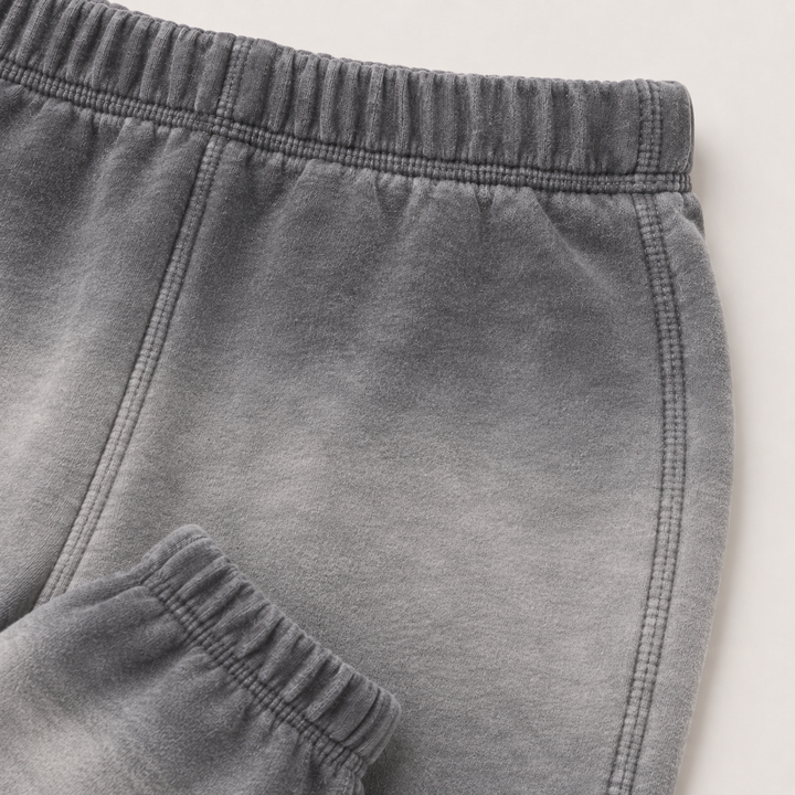 Close-up of PAIGELAUREN Ombre Gray dip dye fleece sweatpant construction and elastic waistband
