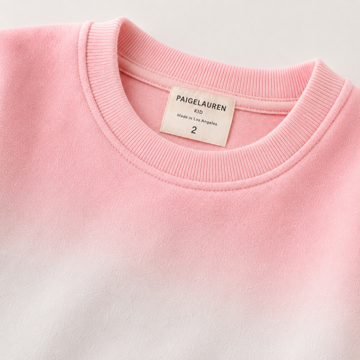 Close-up of PAIGELAUREN Ombre Pink fleece sweatshirt ribbed neckline and label