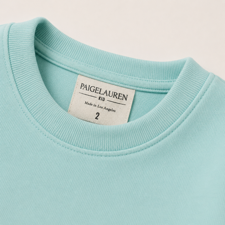 Close-up of PAIGELAUREN Ombre Teal fleece sweatshirt ribbed neckline and label