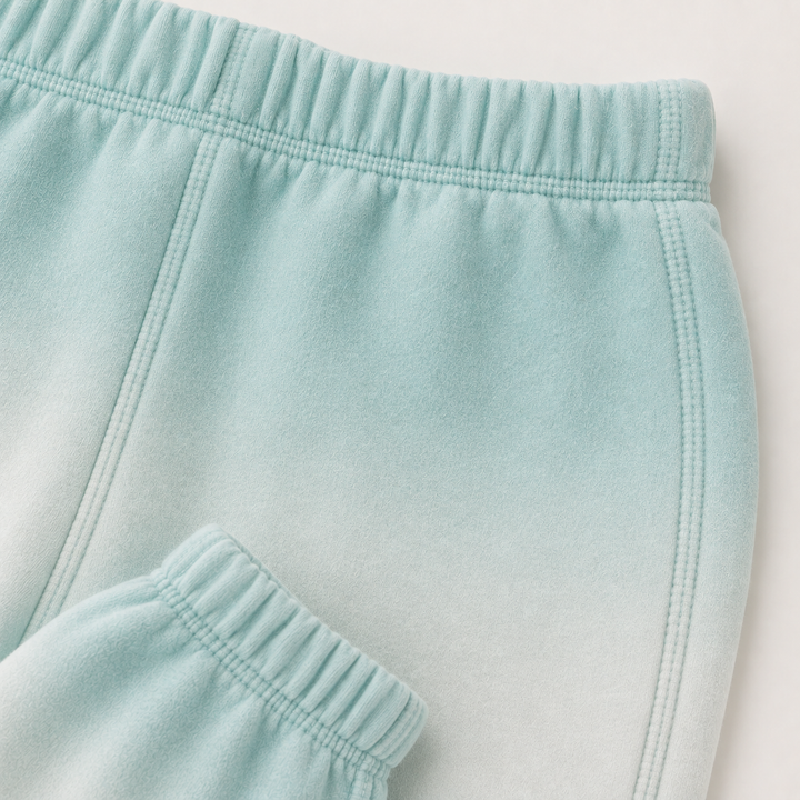 Close-up of PAIGELAUREN Ombre Teal dip dye fleece sweatpant construction and elastic waistband