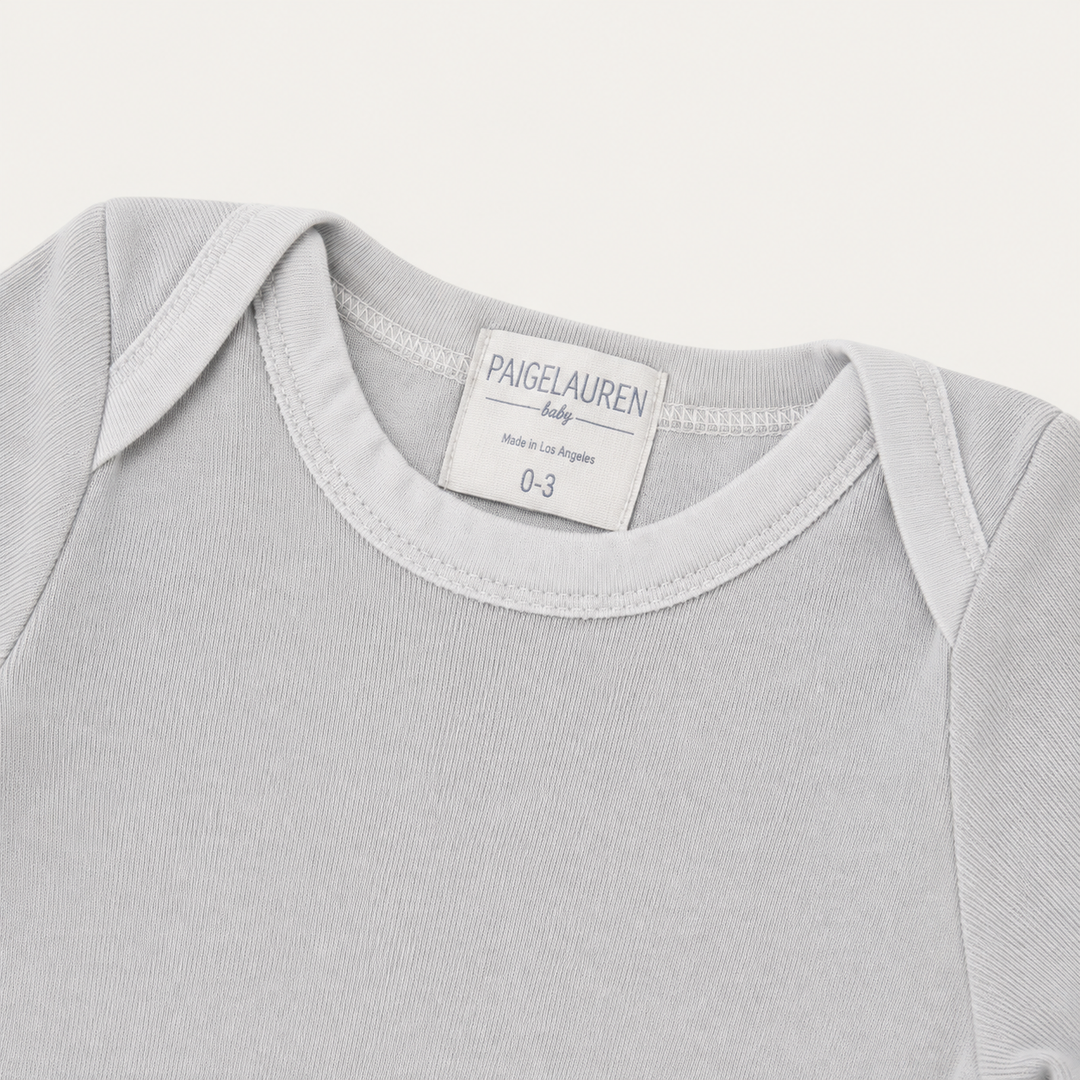 Lap shoulder neckline detail on PAIGELAUREN Gray Fleece Newborn Footed Romper