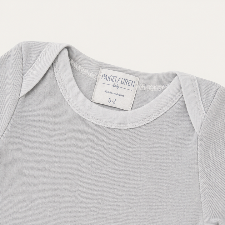 Lap shoulder neckline detail on PAIGELAUREN Gray Fleece Newborn Footed Romper