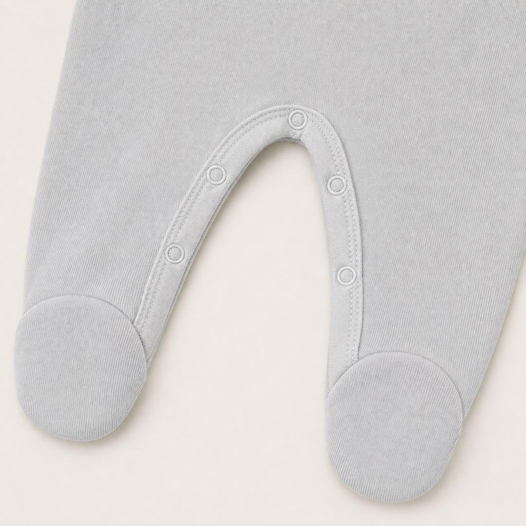nseam snap closure and built-in footie detail on PAIGELAUREN Gray Fleece Newborn Romper