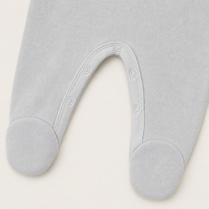 nseam snap closure and built-in footie detail on PAIGELAUREN Gray Fleece Newborn Romper
