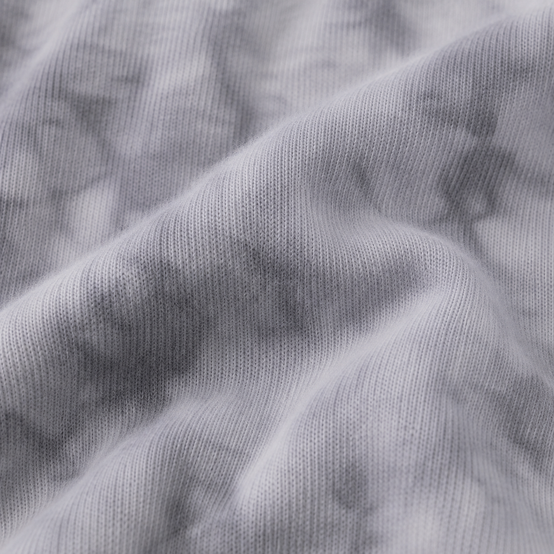 Close-up of ultra-soft Gray Marble brushed hacci fabric showing its fuzzy texture and tonal dye