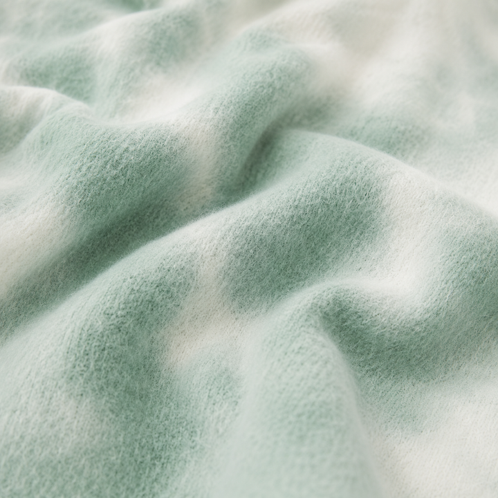 Close-up of soft fuzzy PAIGELAUREN Brushed Hacci Green Tie Dye fabric