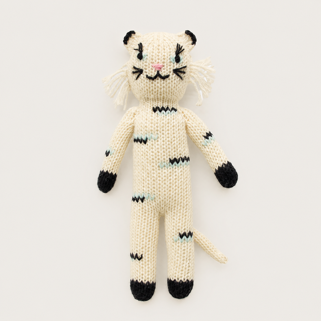 Hand knit cat baby toy in cream with embroidered face and mint details