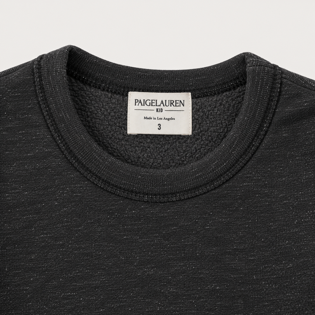 Close-up of PAIGELAUREN Heathered Black fleece sweatshirt neckline, label and soft fleece interior