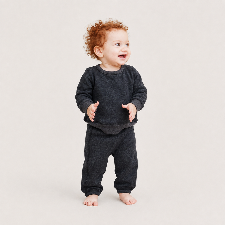 Toddler wearing PAIGELAUREN Heathered Black Fleece Sweatshirt and Pant Set