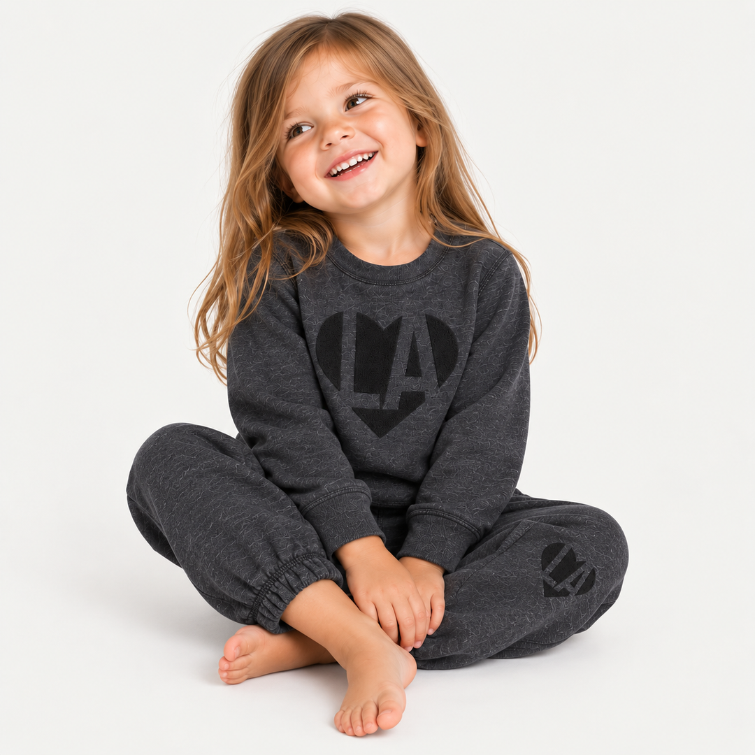 Girl wearing PAIGELAUREN Heathered Black Fleece Puffed Heart LA Sweat Set