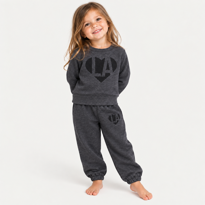 Toddler wearing PAIGELAUREN Heathered Black Fleece Puffed Heart LA Sweat Set