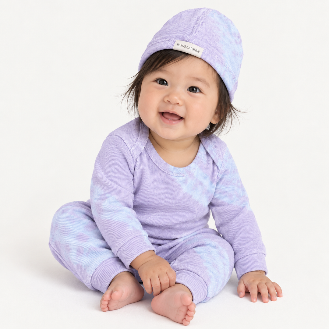 Baby wearing PAIGELAUREN Lavender Blue Tie Dye Ribbed Beanie, Lap Tee and Legging Set