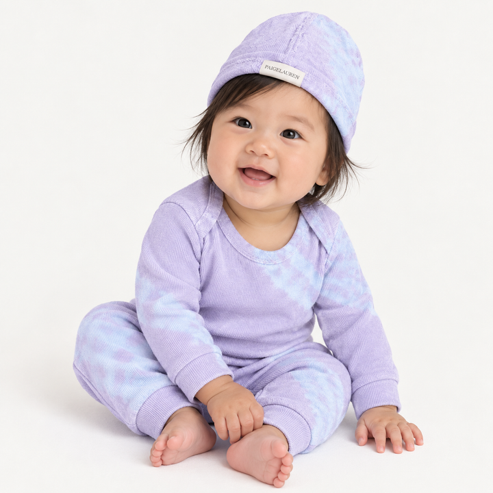 Baby wearing PAIGELAUREN Lavender Blue Tie Dye Ribbed Beanie, Lap Tee and Legging Set