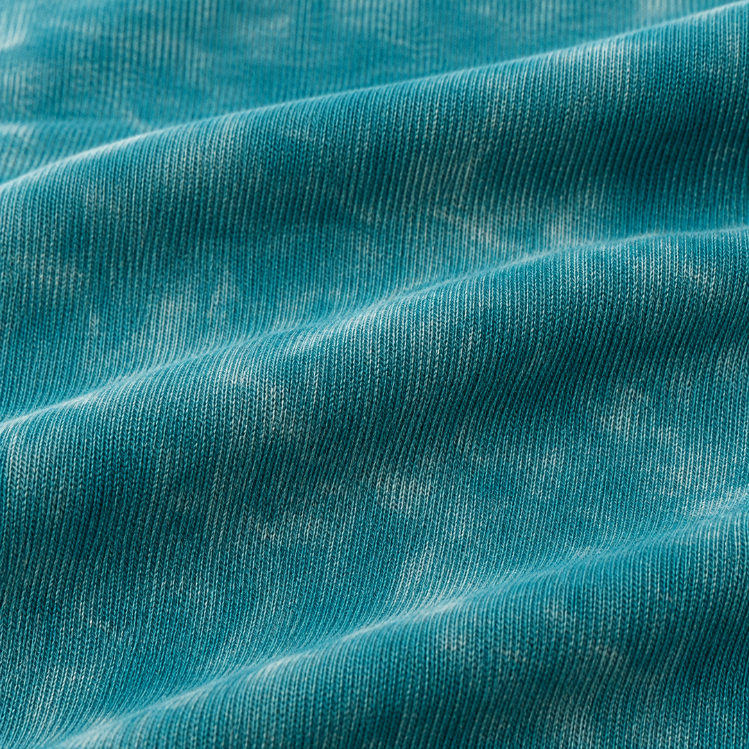 Close-up of soft baby rib fabric with mineral wash texture in Aqua