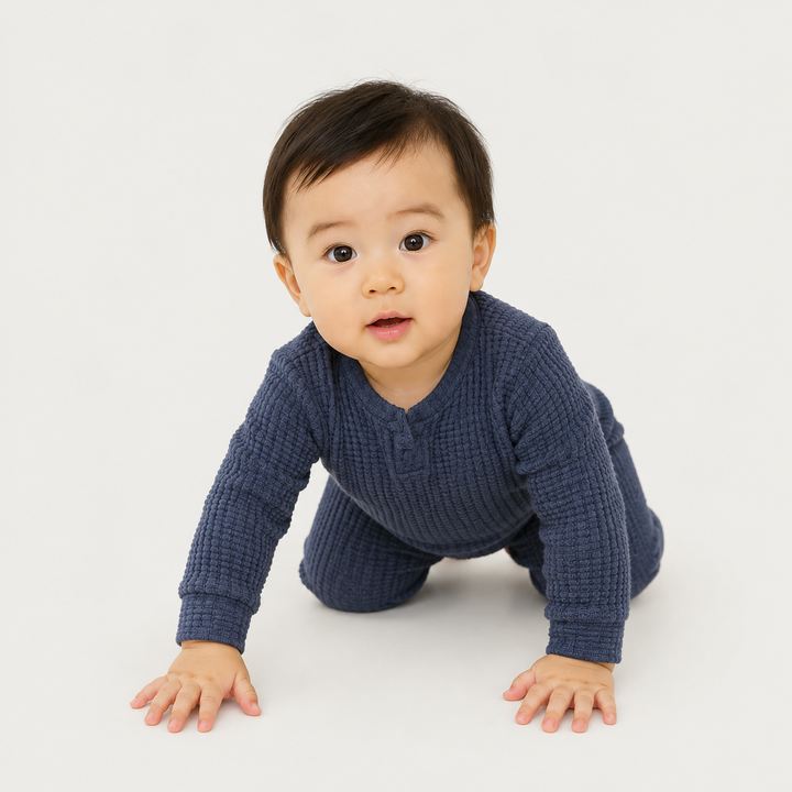Crawling baby wearing the PAIGELAUREN Navy Chunky Thermal Romper.