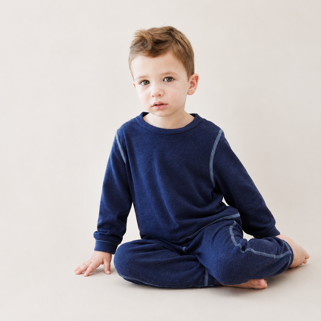 Toddler sitting and wearing PAIGELAUREN Lightweight Navy Hacci Pullover & Pant Loungewear Set