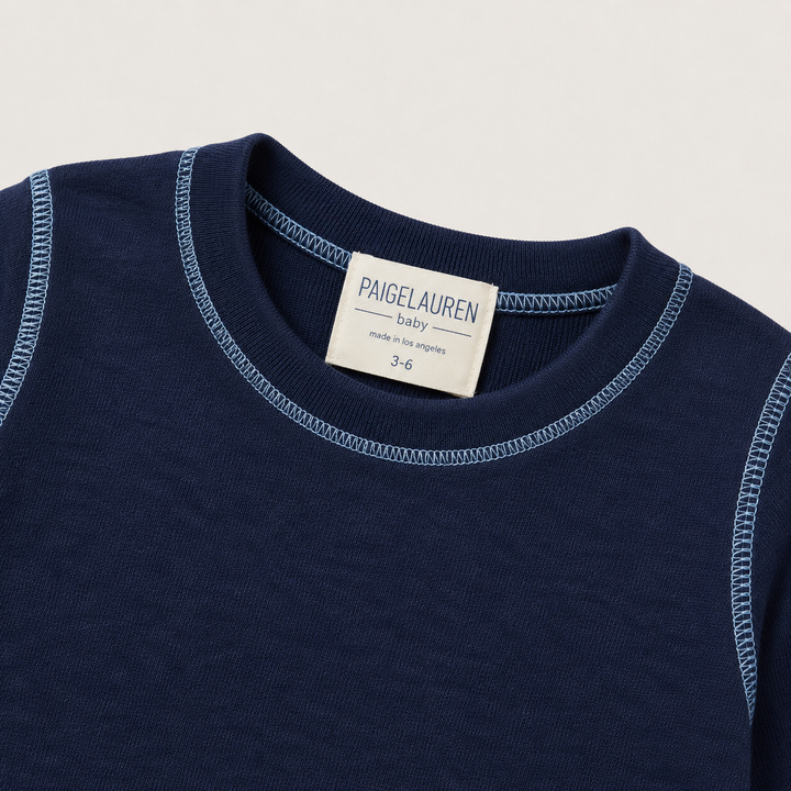 Close-up of PAIGELAUREN Navy Hacci Pullover neckline with light blue contrast topstitching
