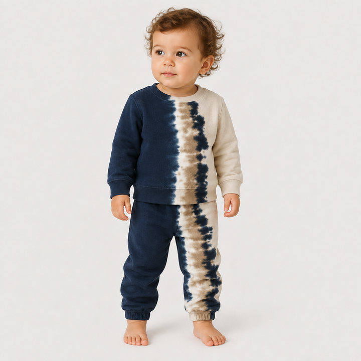 Toddler standing wearing the PAIGELAUREN Super Soft Fleece Tie Dye Set in Navy Tie Dye