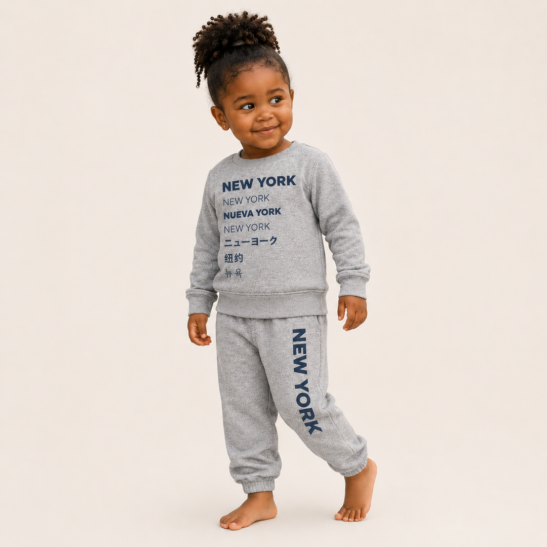 Lifestyle Toddler wearing PAIGELAUREN New York graphic Vintage Heathered Fleece loungewear set