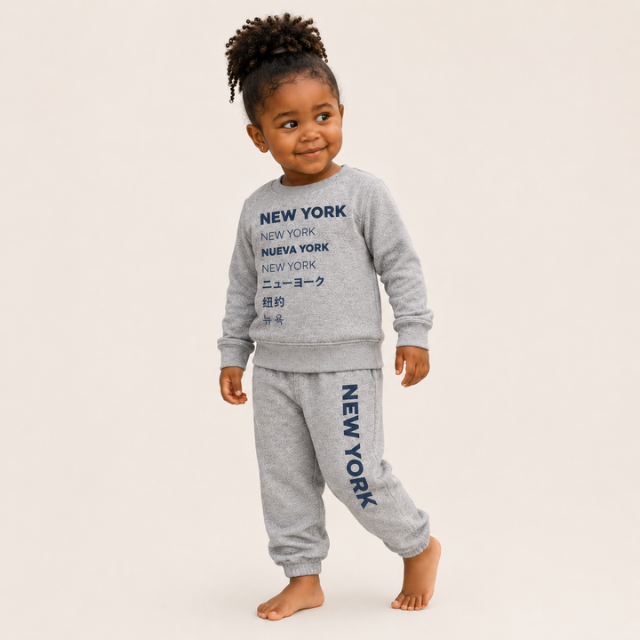 Lifestyle Toddler wearing PAIGELAUREN New York graphic Vintage Heathered Fleece loungewear set