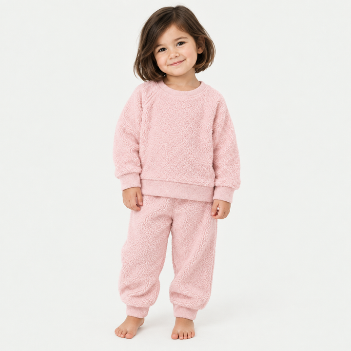 Girl wearing PAIGELAUREN Pink Fluffy Sherpa Sweatshirt and Jogger Set