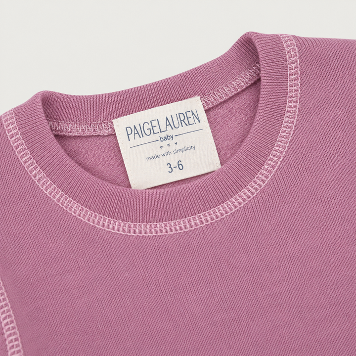 Close-up of PAIGELAUREN Pink Hacci Pullover neckline with light pink contrast topstitching