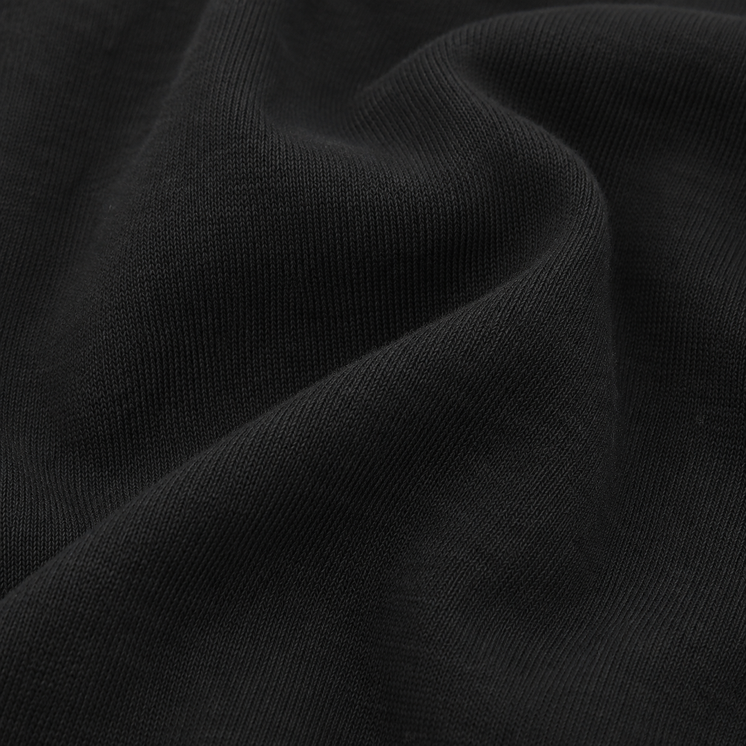 Close-up of soft Black rib fabric on PAIGELAUREN baby footie pajama