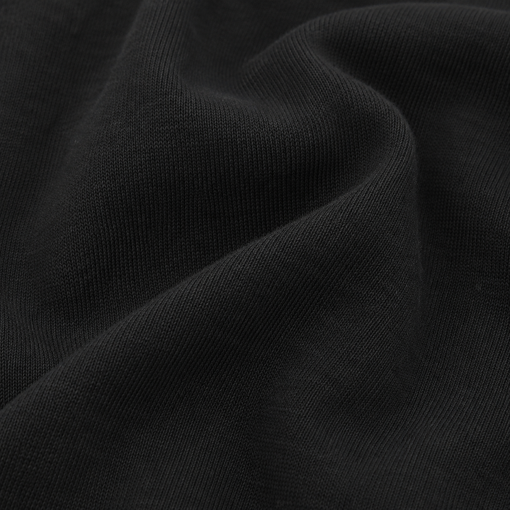 Close-up of soft Black rib fabric on PAIGELAUREN baby footie pajama