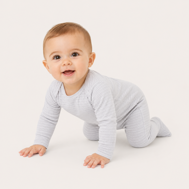 Baby crawling in PAIGELAUREN Heathered Gray Rib Lap Tee Footie Pajama