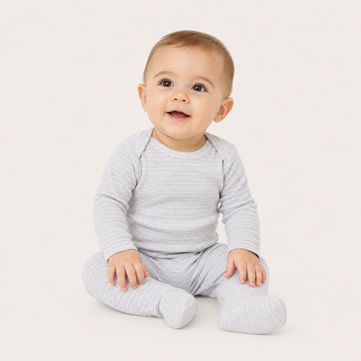Baby sitting in PAIGELAUREN Rib Lap Tee Footie Pajama in Heathered Gray