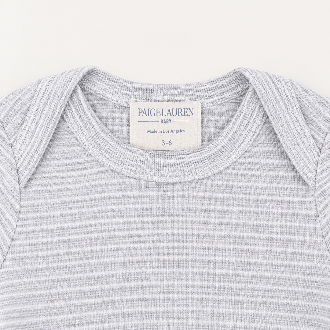 Lap shoulder neckline detail on PAIGELAUREN Heathered Gray Rib Footie Pajama