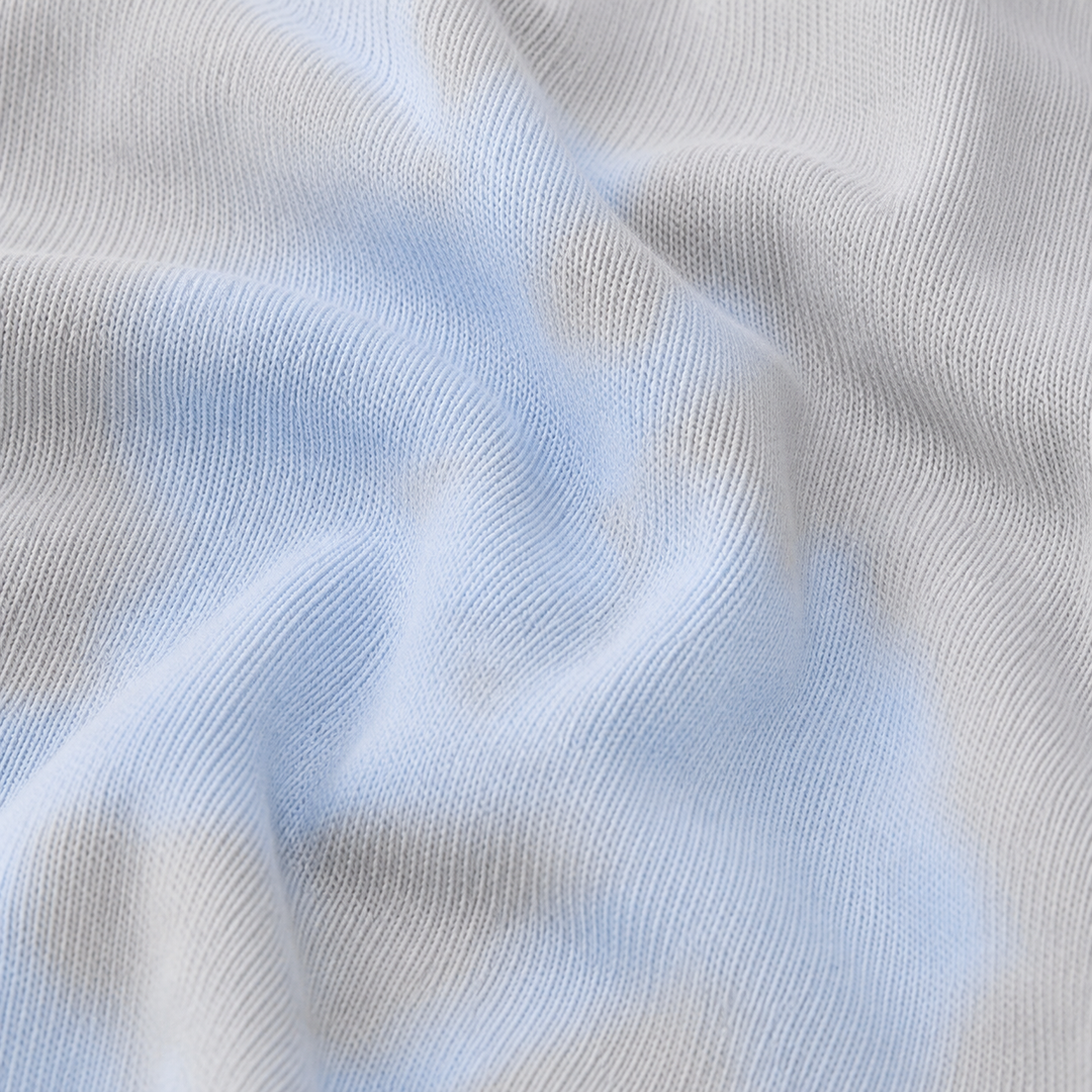Close-up of soft rib knit and oat and blue tie-dye detail on PAIGELAUREN pajama