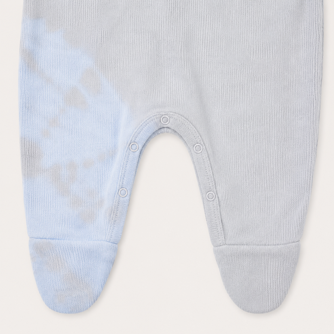 Inseam snap closure and footie detail of PAIGELAUREN oat and blue Rib Tie Dye Pajama