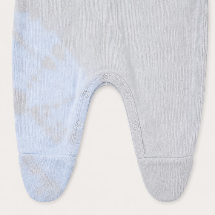 Inseam snap closure and footie detail of PAIGELAUREN oat and blue Rib Tie Dye Pajama