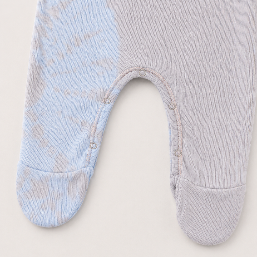 Inseam snap and footie detail of PAIGELAUREN pink and blue Rib Tie Dye Pajama