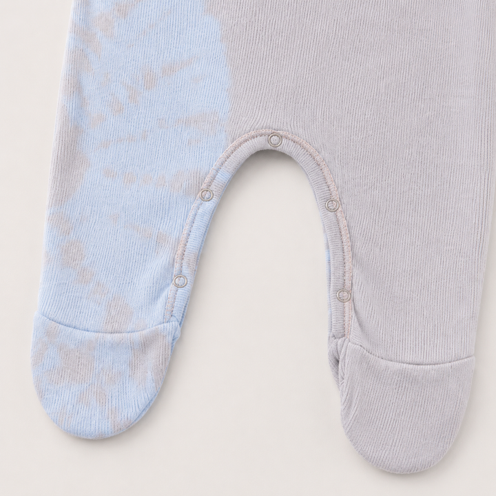 Inseam snap and footie detail of PAIGELAUREN pink and blue Rib Tie Dye Pajama