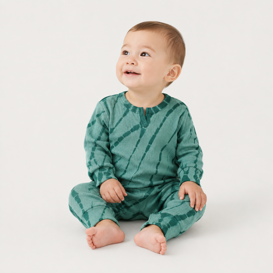 Baby wearing the PAIGELAUREN Ribbed green Tonal Tie Dye Henley Romper.